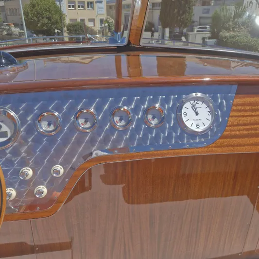  Yacht Photos Pics Dashboard of a 2010 J Craft Torpedo 42 with wood finish and analog clock.