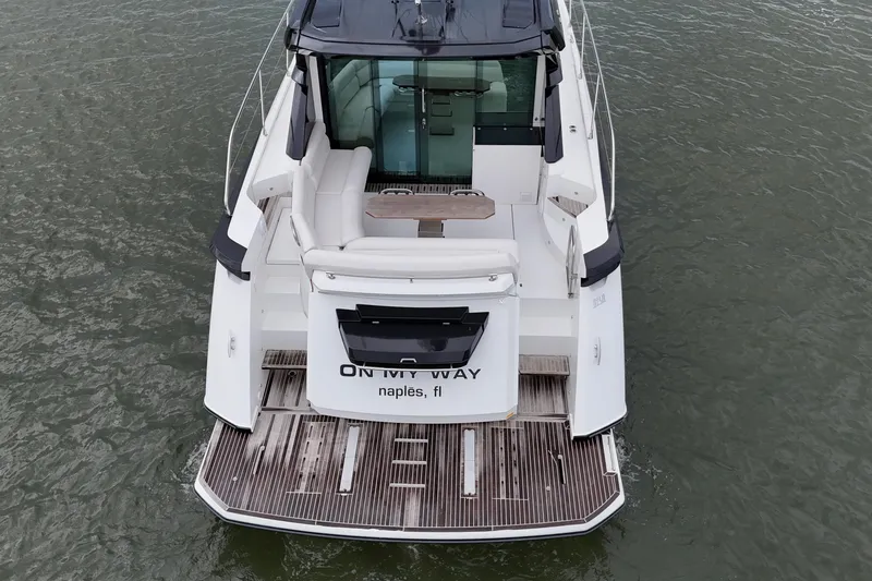On My Way Yacht Photos Pics 2018 Beneteau Gran Turismo 50 yacht, rear view, docked in water, Naples, FL.