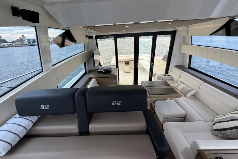On My Way Yacht Photos Pics Luxurious interior of 2018 Beneteau Gran Turismo 50 yacht with panoramic windows and plush seating.