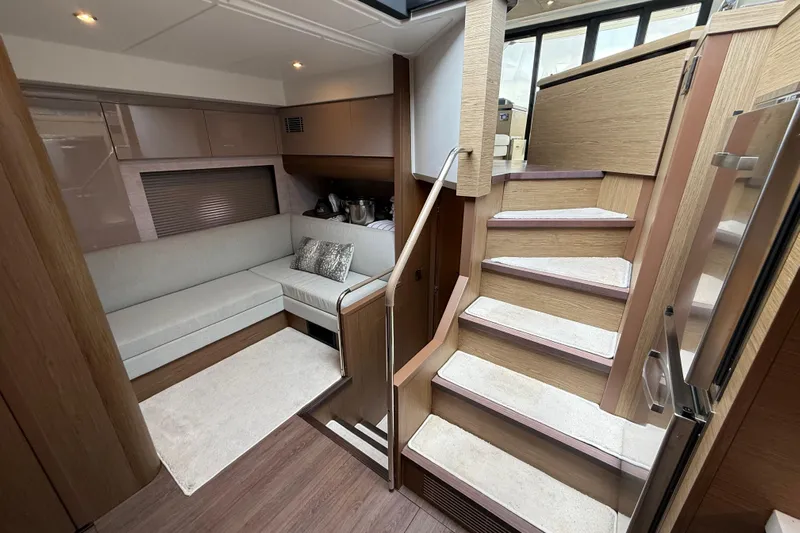 On My Way Yacht Photos Pics Luxurious interior of 2018 Beneteau Gran Turismo 50 yacht with modern seating and staircase.