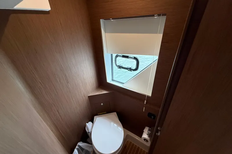 On My Way Yacht Photos Pics 2018 Beneteau Gran Turismo 50 yacht bathroom with wooden interior and window.