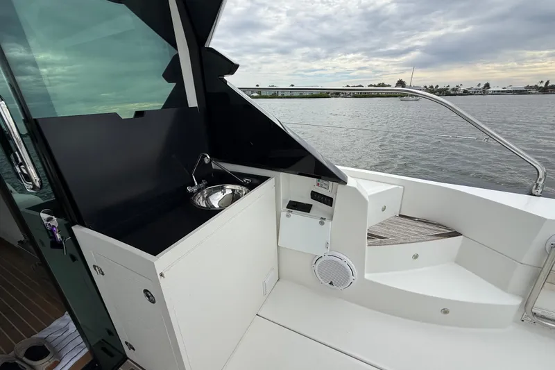 On My Way Yacht Photos Pics 2018 Beneteau Gran Turismo 50 yacht with outdoor sink and scenic water view.