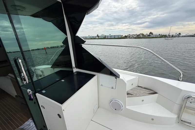 On My Way Yacht Photos Pics 2018 Beneteau Gran Turismo 50 yacht deck with scenic waterfront view.