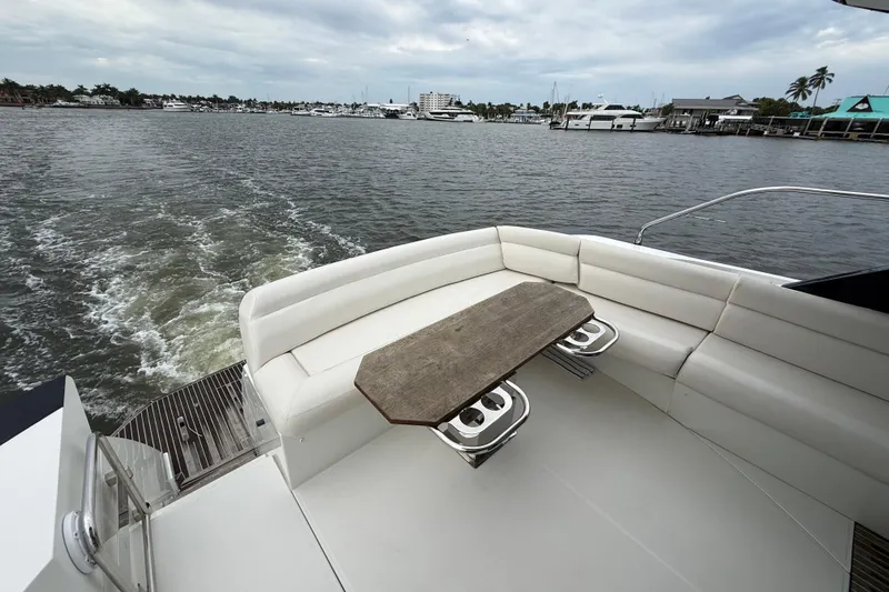 On My Way Yacht Photos Pics 2018 Beneteau Gran Turismo 50 yacht with elegant seating and scenic water view.