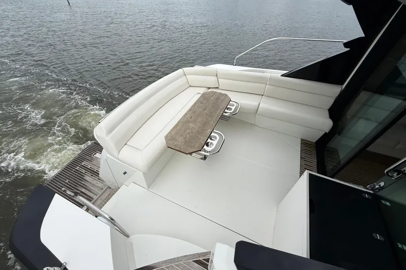 On My Way Yacht Photos Pics 2018 Beneteau Gran Turismo 50 yacht with elegant seating and table on deck.