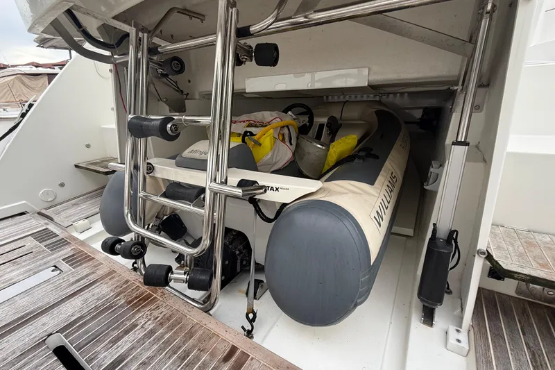 On My Way Yacht Photos Pics 2018 Beneteau Gran Turismo 50 yacht with stored inflatable boat in rear compartment.