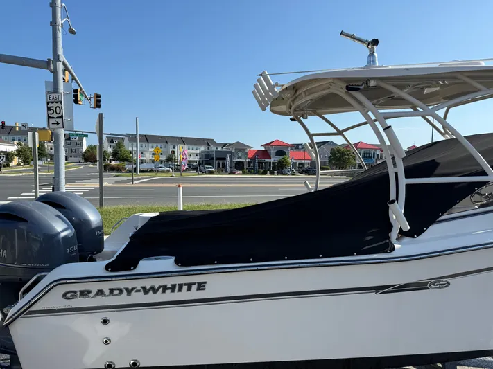  Yacht Photos Pics 2018 Grady-White Freedom 275 boat parked near a street intersection.