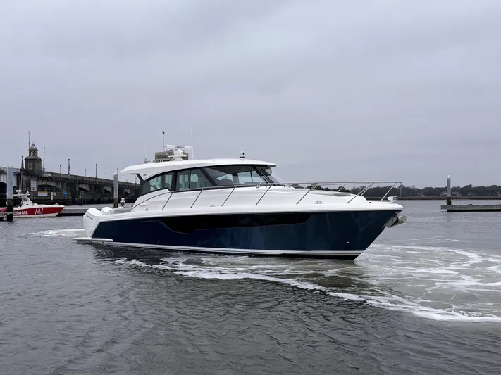 Hail Mary Yacht Photos Pics 2024 Tiara Yachts 48 LE cruising on a cloudy day in a marina.