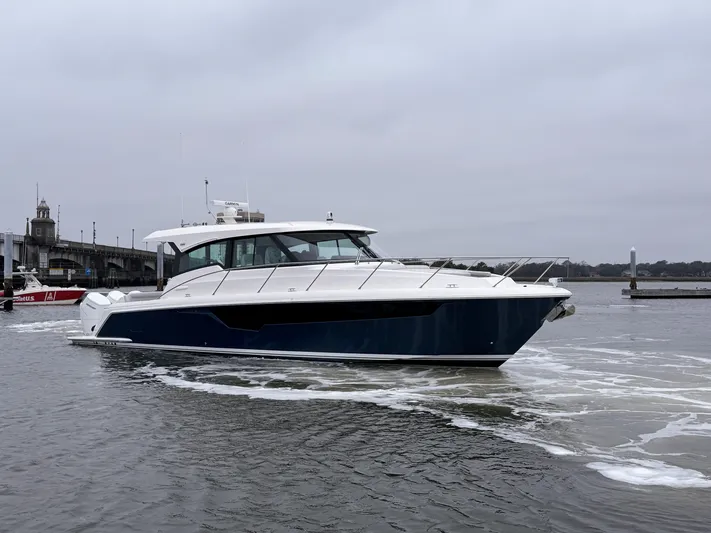 Hail Mary Yacht Photos Pics 2024 Tiara Yachts 48 LE cruising on a calm, overcast waterway.