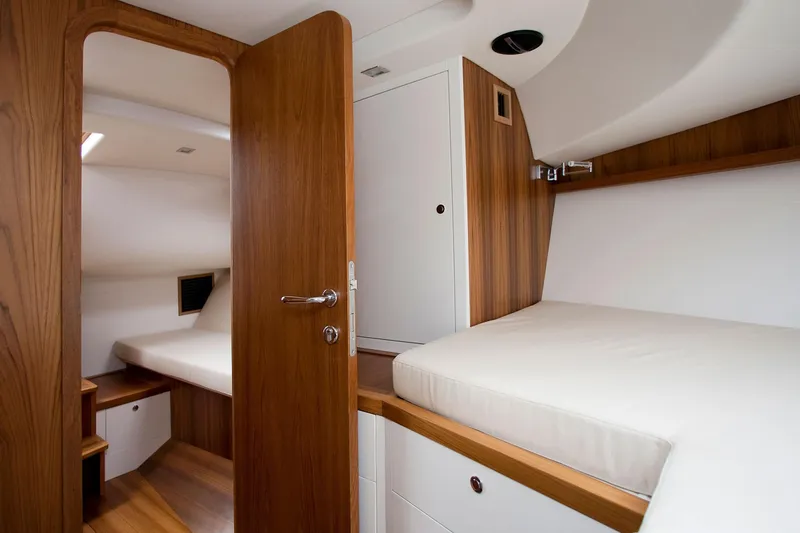  Yacht Photos Pics Modern yacht interior with wooden finishes and cozy sleeping quarters, Toy 36 model, 2025.