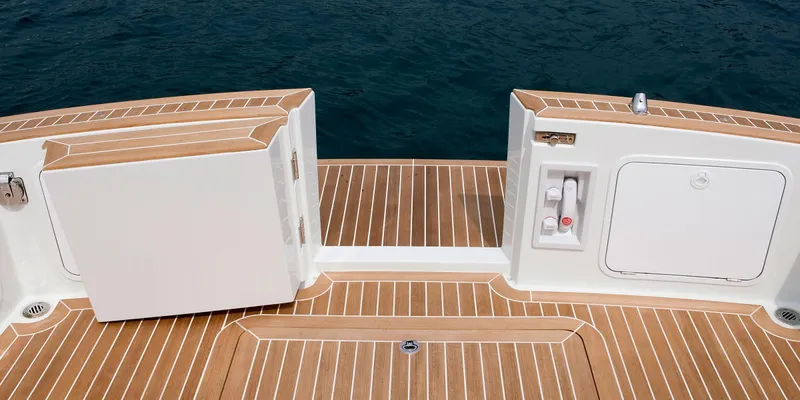 Yacht Photos Pics Luxury boat deck with teak flooring, featuring storage compartments. Toy 36, 2025 model.