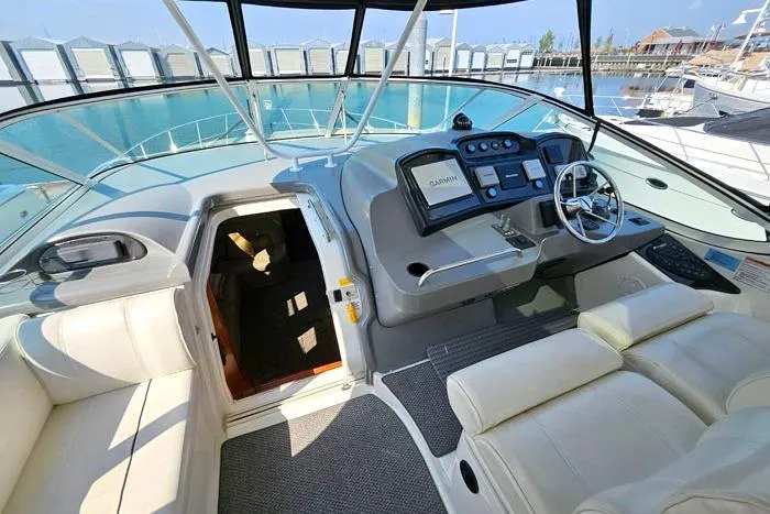  Yacht Photos Pics 2006 Cruisers Yachts 455 Express Motoryacht helm with luxurious seating and modern navigation equipment.