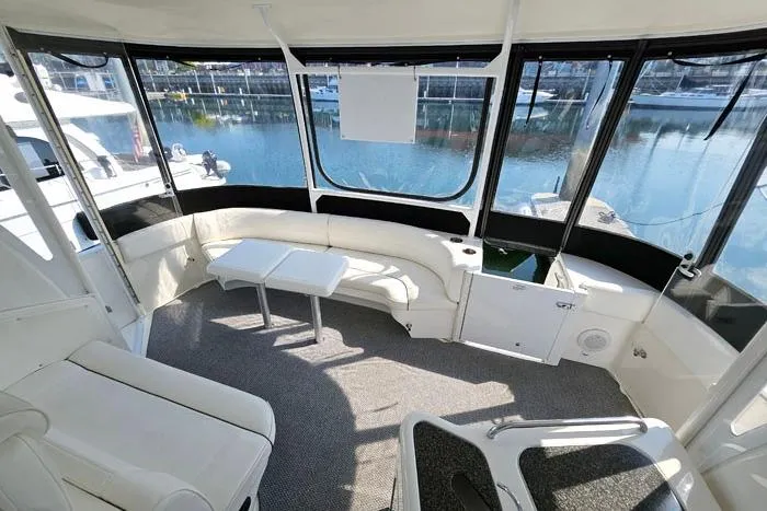  Yacht Photos Pics 2006 Cruisers Yachts 455 Express Motoryacht interior with seating and waterfront view.