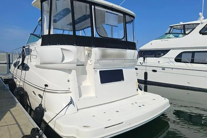  Yacht Photos Pics 2006 Cruisers Yachts 455 Express Motoryacht docked at marina, rear view.