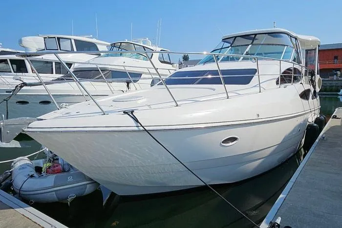  Yacht Photos Pics 2006 Cruisers Yachts 455 Express Motoryacht docked at marina, side view.