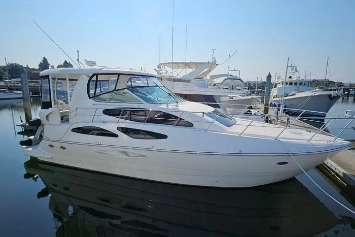  Yacht Photos Pics 2006 Cruisers Yachts 455 Express Motoryacht docked at marina, side view.