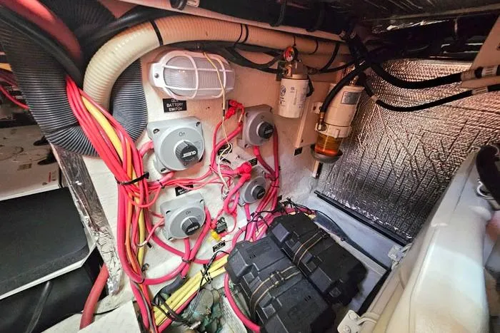  Yacht Photos Pics Engine room of 2006 Cruisers Yachts 455 Express Motoryacht with wiring and battery switches.