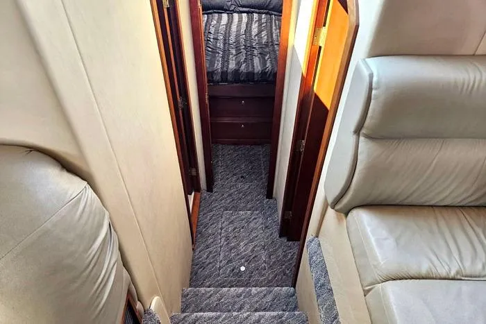  Yacht Photos Pics Interior view of 2006 Cruisers Yachts 455 Express Motoryacht, featuring stairs and cozy cabin.