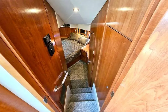  Yacht Photos Pics 2006 Cruisers Yachts 455 Express Motoryacht interior with wooden finish and cozy bedroom.