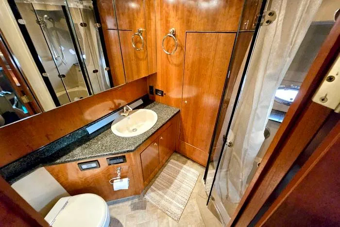  Yacht Photos Pics Luxurious bathroom in 2006 Cruisers Yachts 455 Express Motoryacht with wood cabinetry and modern fixtures.