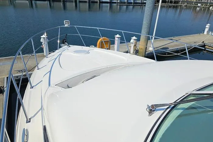  Yacht Photos Pics 2006 Cruisers Yachts 455 Express Motoryacht docked at marina, showcasing sleek deck design.