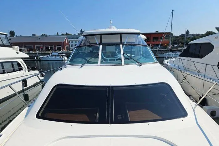  Yacht Photos Pics 2006 Cruisers Yachts 455 Express Motoryacht docked at marina, front view.