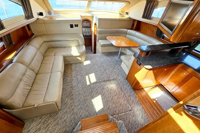  Yacht Photos Pics Luxurious interior of 2006 Cruisers Yachts 455 Express Motoryacht with plush seating and elegant wood finishes.