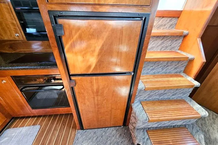  Yacht Photos Pics Interior of 2006 Cruisers Yachts 455 Express Motoryacht with wooden cabinetry and stairs.