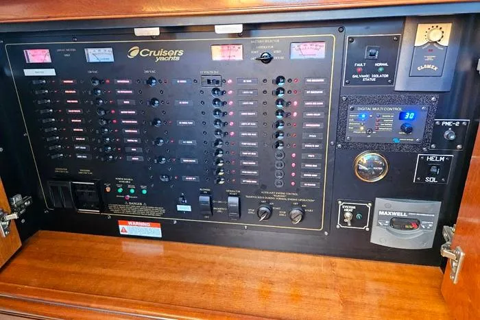  Yacht Photos Pics Electrical control panel of 2006 Cruisers Yachts 455 Express Motoryacht, featuring various switches and gauges.