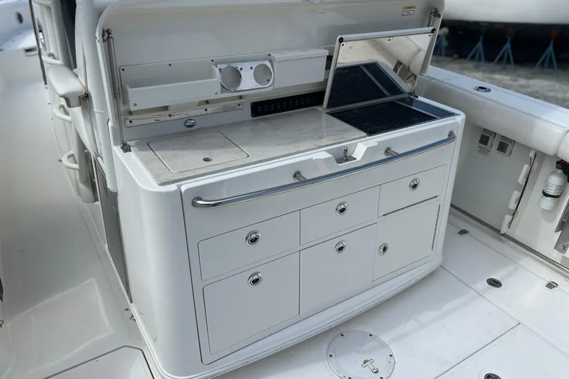  Yacht Photos Pics 2014 Boston Whaler 350 Outrage Summer Kitchen Leaning Post open with Kenyon Grill open, looking from port side