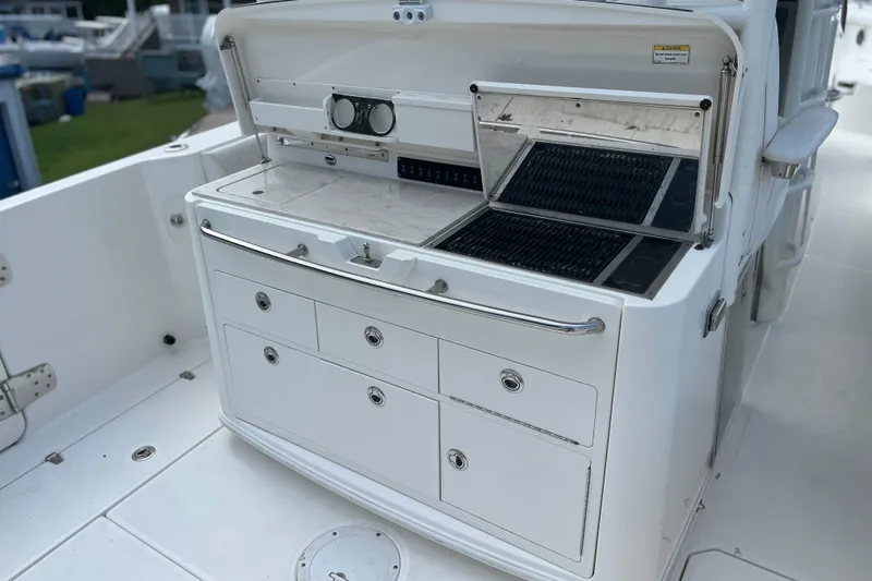  Yacht Photos Pics 2014 Boston Whaler 350 Outrage Summer Kitchen Leaning Post open with Kenyon Grill open, looking from starboard side