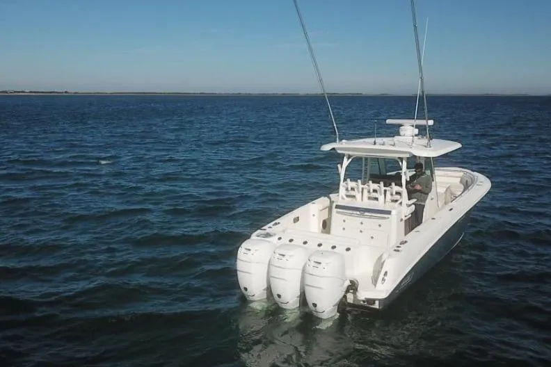  Yacht Photos Pics 2014 Boston Whaler 350 Outrage boat with triple engines on open water.