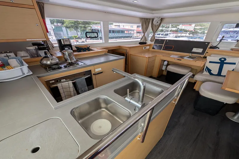  Yacht Photos Pics Interior of 2015 Lagoon 450 catamaran kitchen with modern amenities and nautical decor.