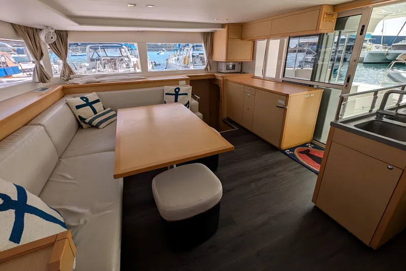  Yacht Photos Pics Interior of 2015 Lagoon 450 catamaran with modern kitchen and seating area.