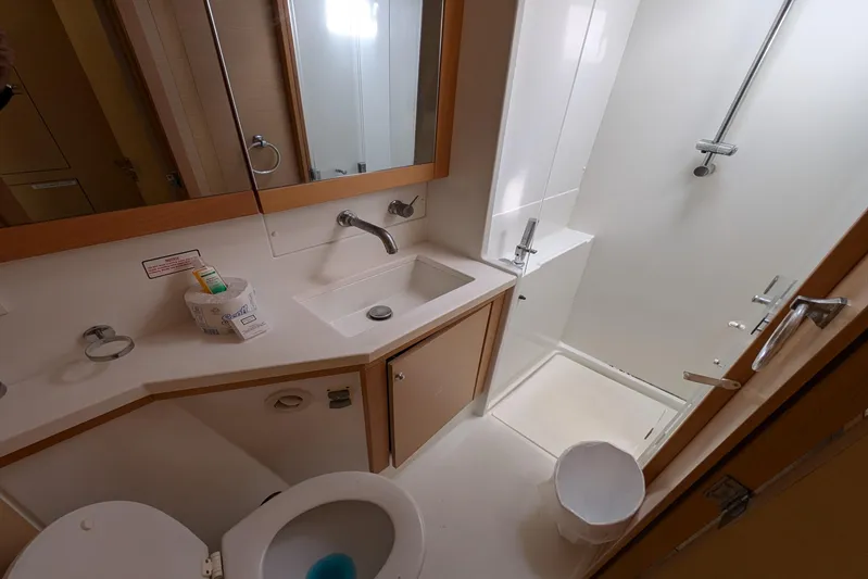  Yacht Photos Pics Bathroom interior of 2015 Lagoon 450 yacht, featuring shower, sink, and toilet.