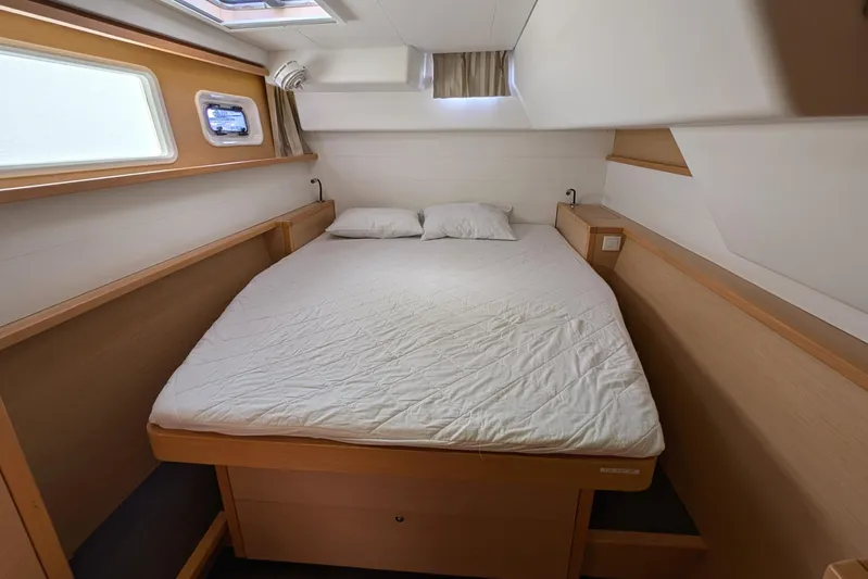  Yacht Photos Pics Cozy cabin interior of 2015 Lagoon 450 catamaran with double bed and natural light.