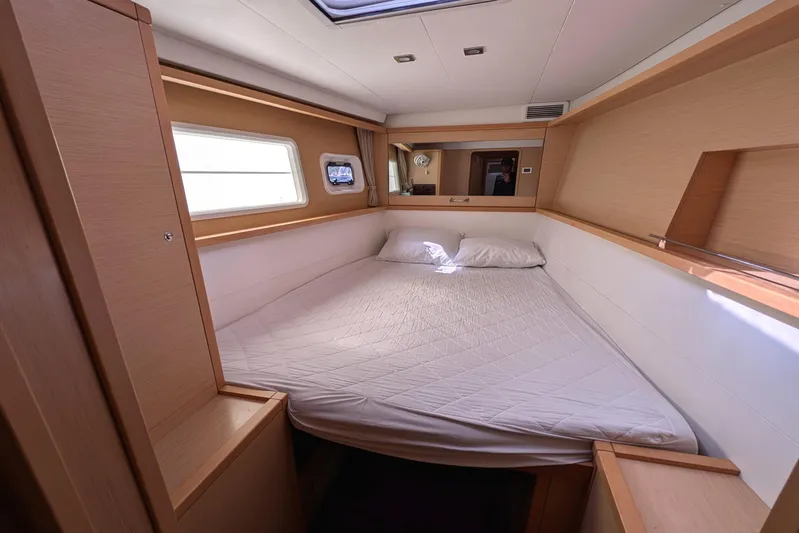  Yacht Photos Pics Cozy cabin interior of 2015 Lagoon 450 catamaran with double bed and natural light.