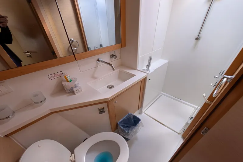  Yacht Photos Pics Bathroom interior of 2015 Lagoon 450 yacht, featuring sink, toilet, and shower.