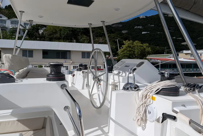  Yacht Photos Pics Cockpit of 2015 Lagoon 450 catamaran with steering wheel and winches, docked at marina.