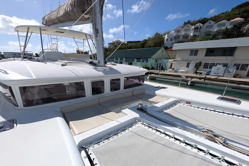  Yacht Photos Pics 2015 Lagoon 450 catamaran docked at marina, featuring spacious deck and seating area.