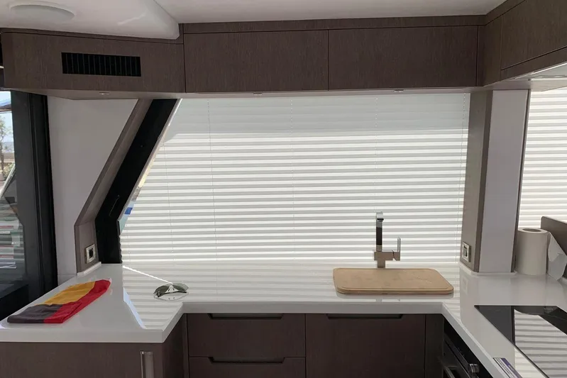  Yacht Photos Pics Modern kitchen interior of 2019 Galeon 500 Fly yacht with sleek countertops and blinds.