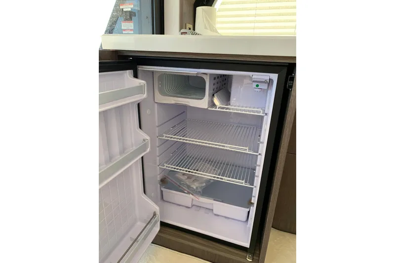  Yacht Photos Pics Open refrigerator inside 2019 Galeon 500 Fly yacht, showcasing spacious interior and shelves.