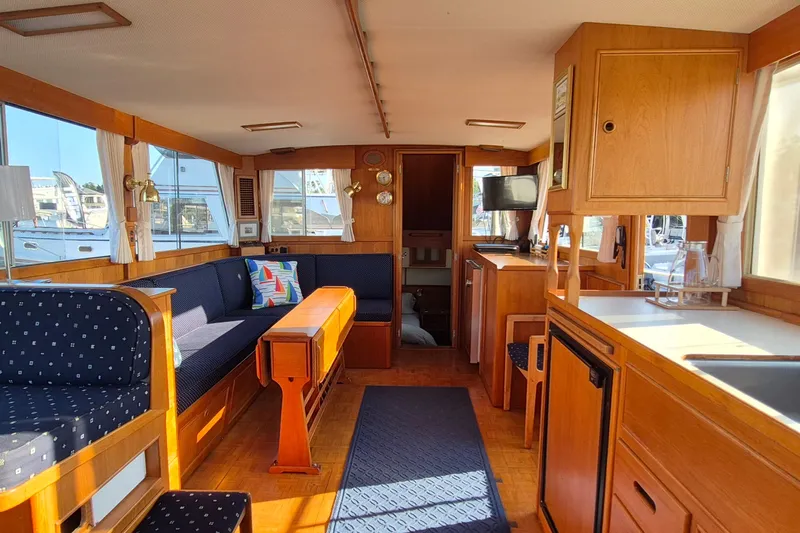Lan Mara Yacht Photos Pics Interior of 1987 Grand Banks 42 Classic Trawler, featuring wood finishes and cozy seating.