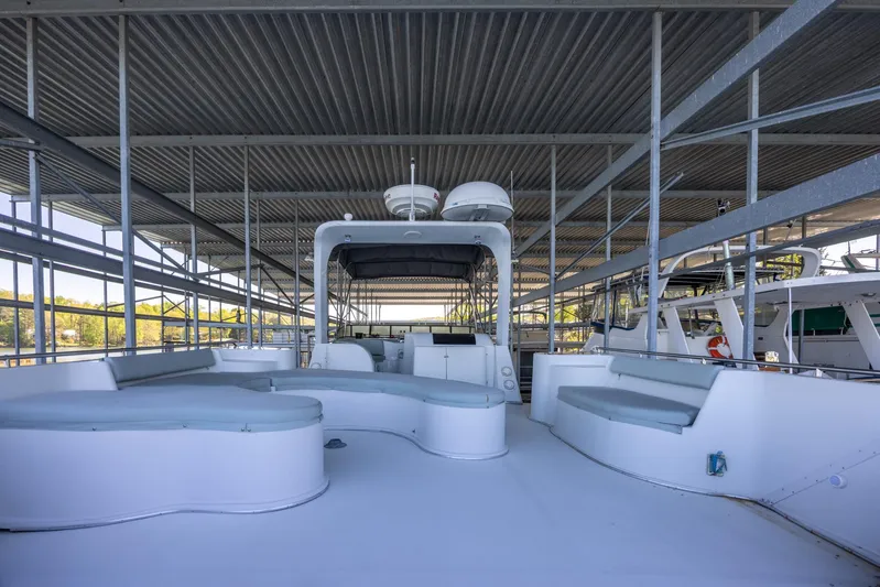  Yacht Photos Pics 1990 Bluewater Yachts 55 Yacht docked under a covered marina, featuring spacious deck seating.