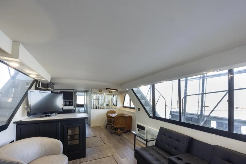  Yacht Photos Pics Interior of 1990 Bluewater Yachts 55 Yacht, featuring modern seating and large windows.