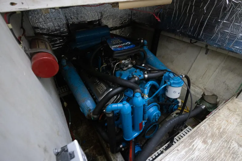  Yacht Photos Pics Engine compartment of a 1990 Bluewater Yachts 55 Yacht, featuring a blue marine engine.