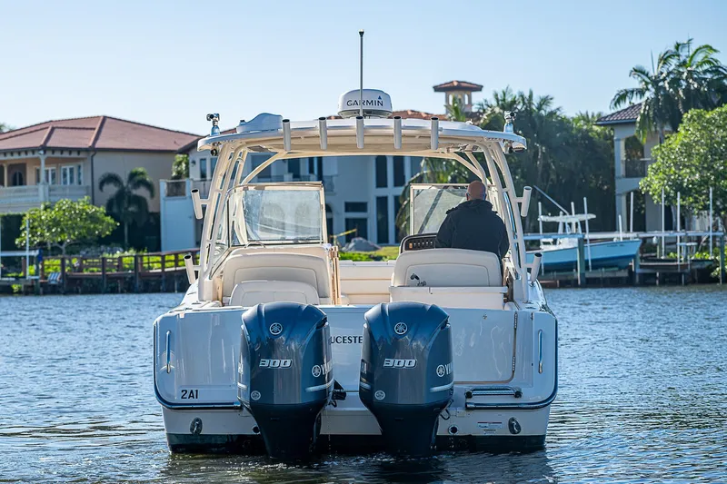 Sundae Funday Yacht Photos Pics 2017 Grady-White Freedom 307 boat with twin engines on a sunny waterfront.