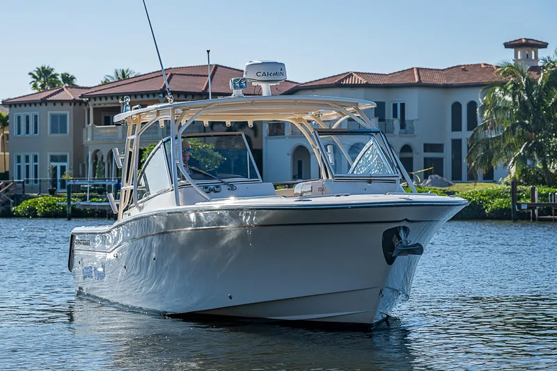 Sundae Funday Yacht Photos Pics 2017 Grady-White Freedom 307 boat on water near luxury waterfront homes.