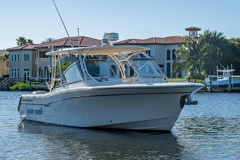 Sundae Funday Yacht Photos Pics 2017 Grady-White Freedom 307 boat on water near luxury waterfront homes.