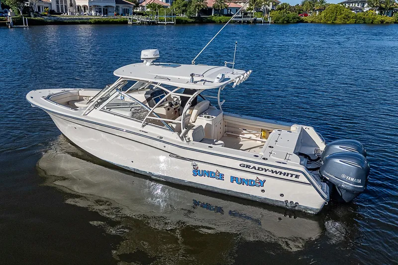 Sundae Funday Yacht Photos Pics 2017 Grady-White Freedom 307 boat on calm water, featuring dual Yamaha engines.